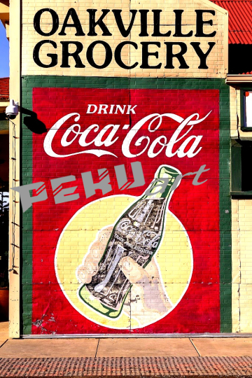 vintage-coca-cola-sign-on-an-outside-wall-of-a-grocery-store